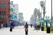 Pedestrians in the sidewalk along a beach front shopping center in Los Angeles.