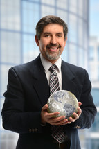 Businessman holding a globe 