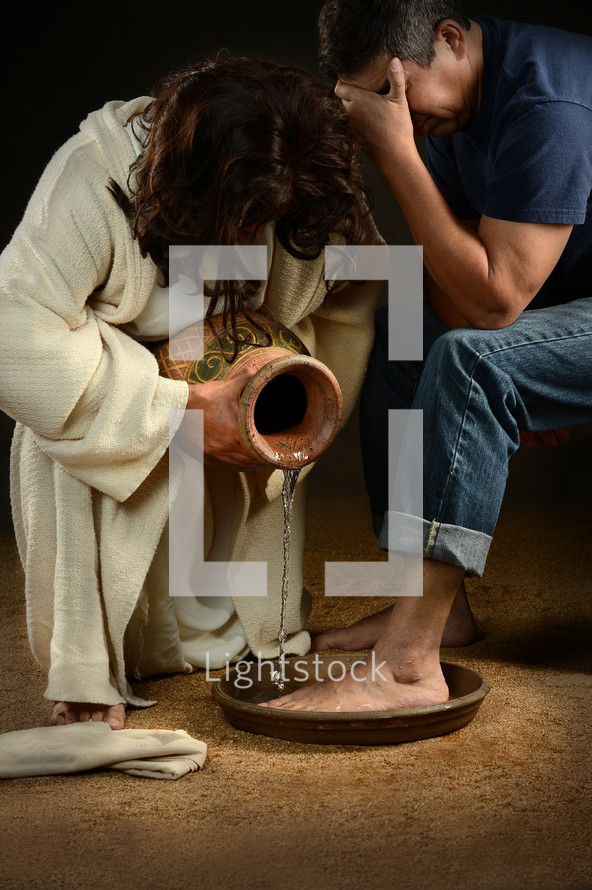 Jesus washing the feet of a man.