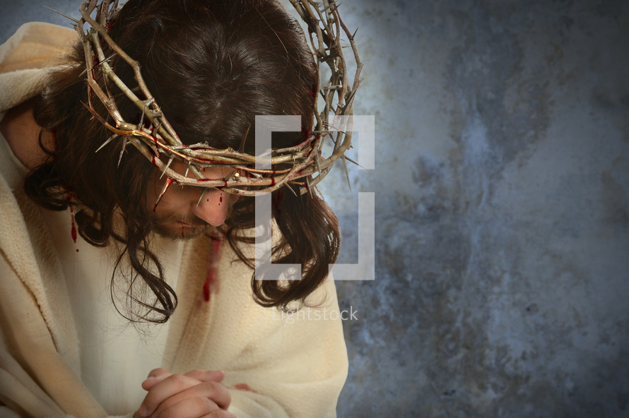 Jesus with a crown of thorns praying 