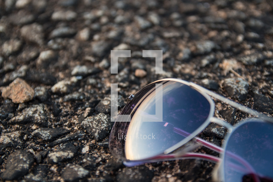 sunglasses on pavement 