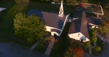 Aerial view over a rural church in fall 