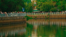 People are standing next to the river bank
