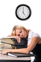 overworked woman sleeping on a stack of books 
