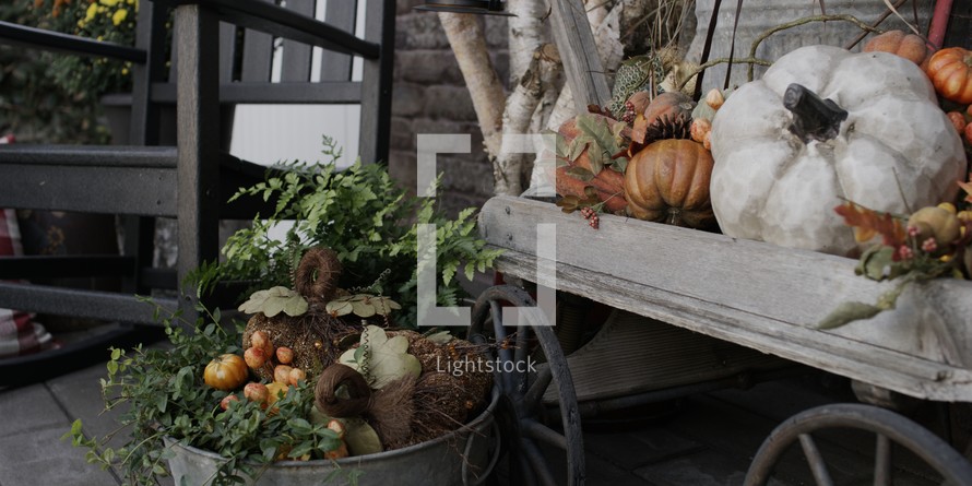 fall decorations on a porch 