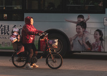 a mother with her child on a bicycle 