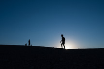 silhouette of a person hiking 