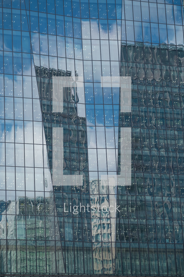 reflection of city buildings in a skyscrapers windows 