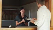 a receptionist greeting a patient in the office 