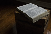 open Bible on a wood crate 