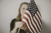 woman holding an American flag 