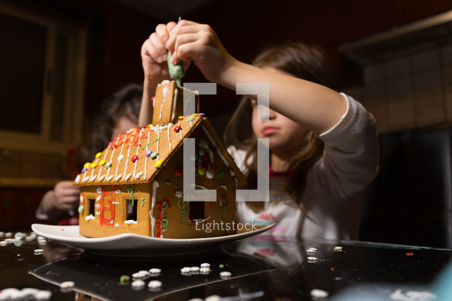 kids building gingerbread houses 