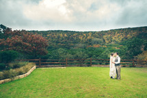 bride and groom kissing in a pasture 