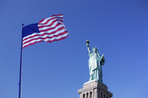 Statue of Liberty and the US Flag, New York City, New York. USA.