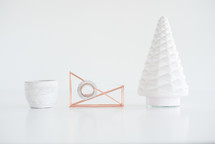 white Christmas tree figurine, tape dispenser, and candle 