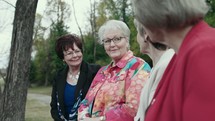 elderly women talking outdoors 