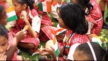 school girls in India waving flags 