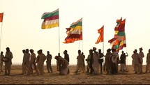 drums, walking, desert, sand, India, men, tribesmen, outdoors, colorful, flags, blowing, breeze, wind