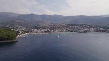 Aerial View Of Spile Beach Coastline With Mountains In Background. Slow Orbit Motion Over Ionian Sea, Establishing Shot