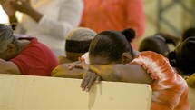 praying during a worship service in Haiti 