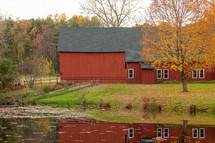 Connecticut red barn in autumn with reflection in pond