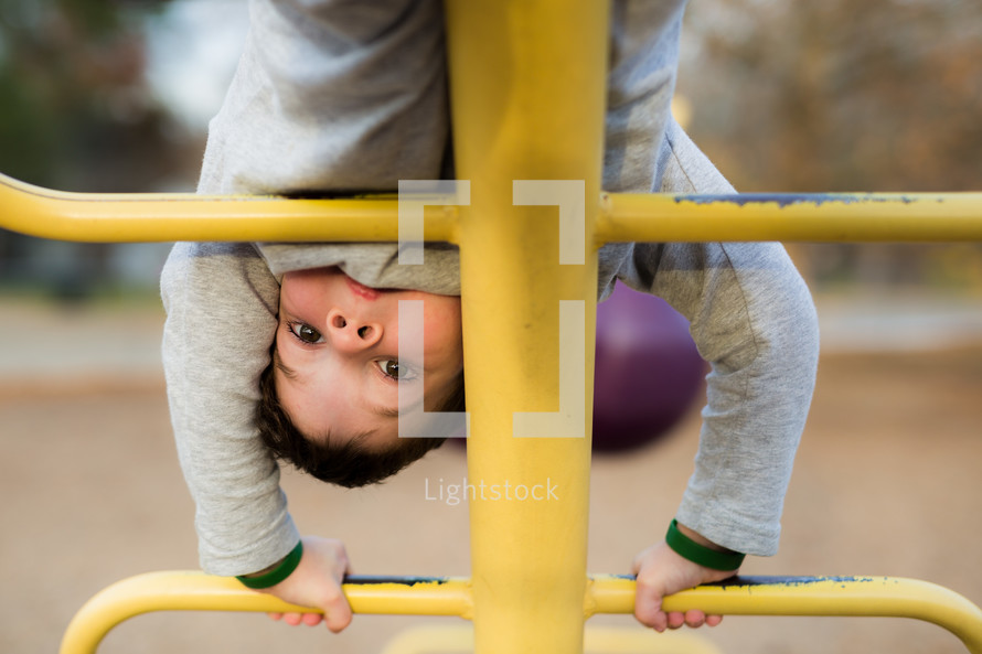 a boy on a climber on a playground 