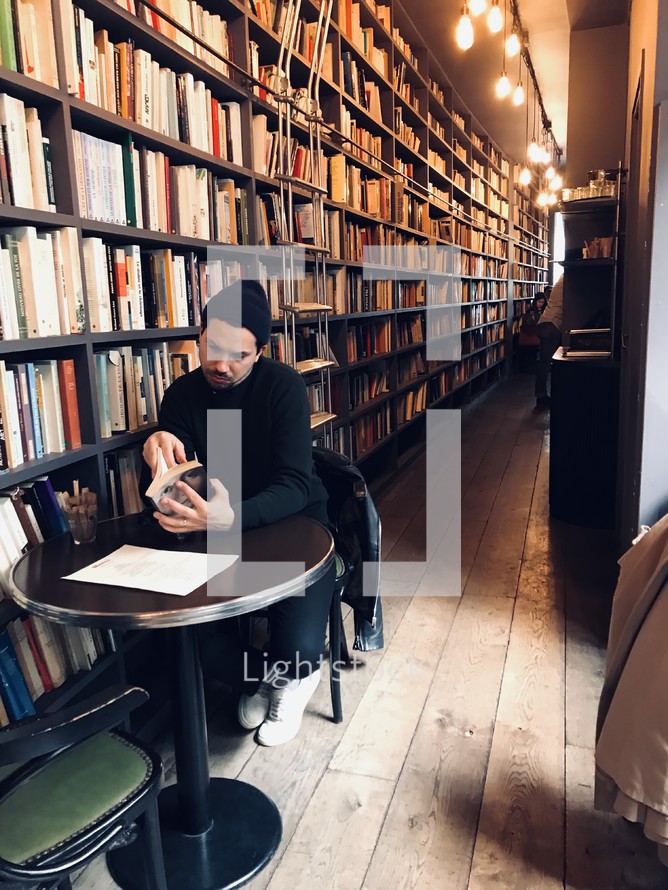 man reading in a library 