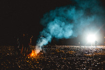 standing around a campfire 