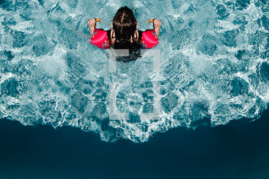 a girl swimming in a pool 