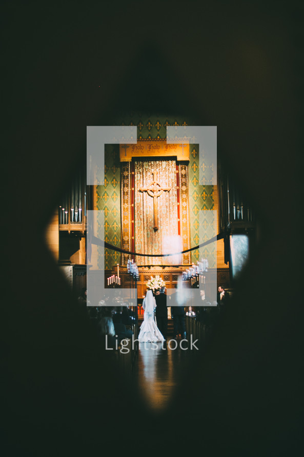 key hole, view of a couple saying vows 