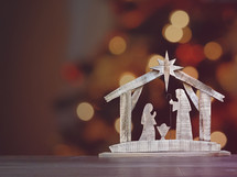 Christmas background with wooden nativity and room for text.