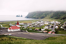 red roof church and homes in a coastal town in Iceland 