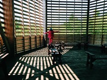 a child walking on a bench in a barn 