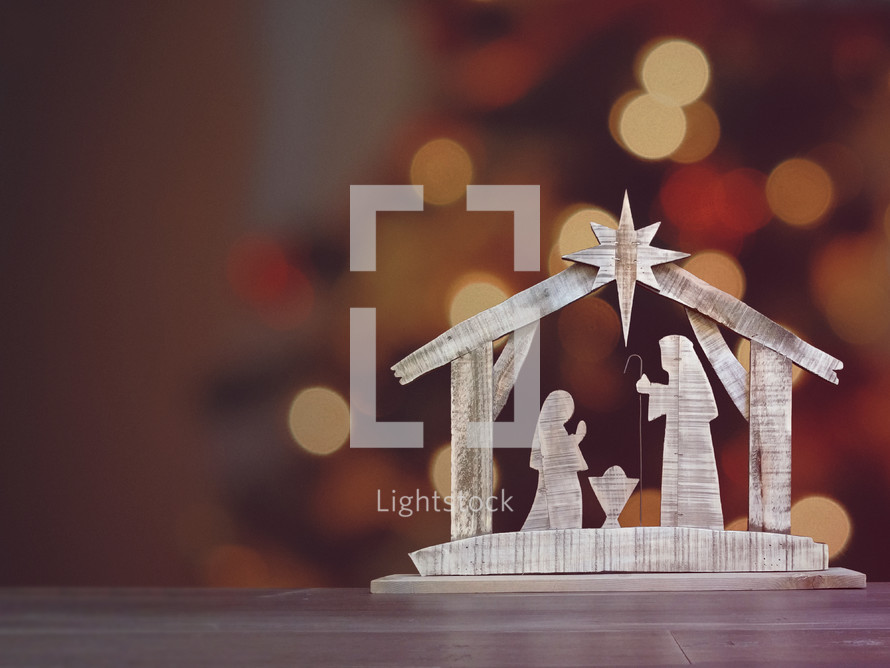 Christmas background with wooden nativity and room for text.