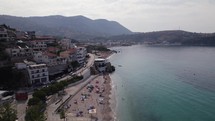 Drone flyover along Himare Coastline, Scenic view of beach shoreline, Albania