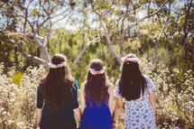 Three girls holding hands in the woods - friendship
