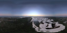 360 aerial photo taken with drone of where sand dunes meet Santo Amaro and a river at sunrise, next to Lençóis Maranhenses National Park in northeast Brazil.