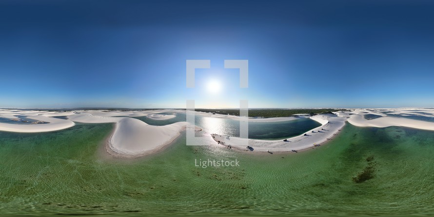 360 aerial photo taken with drone of lagoa surrounded by sand dunes on Ponta Verde tour in Lençóis Maranhenses National Park in northeast Brazil.