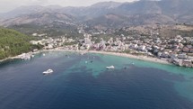 Wide aerial of the picturesque azure coastal shore of Himare, Albania