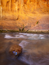 water in a river and red rock cliffs 