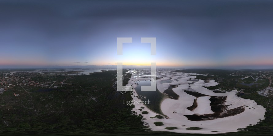 360 aerial photo taken with drone of where sand dunes meet Santo Amaro and a river at sunrise, next to Lençóis Maranhenses National Park in northeast Brazil.