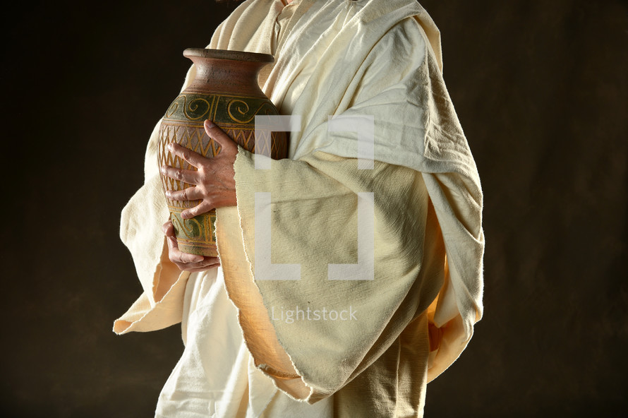 Jesus' hands holding an urn.