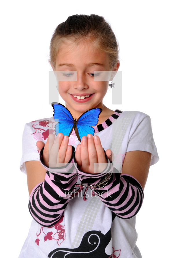 young girl holding a blue butterfly