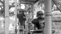 couple standing under an umbrella talking 