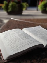open Bible on a table outdoors 