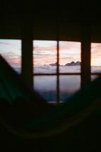view of mountain fog through a window at sunrise 