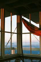 hammock on a deck overlooking mountain fog at sunrise 