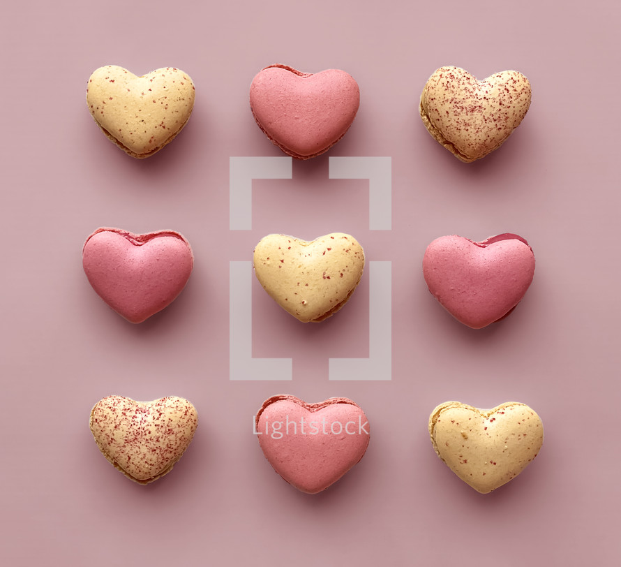 macaron cookies on a pink background for Valentine's Day 