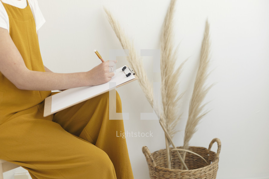 a female holding a clipboard 