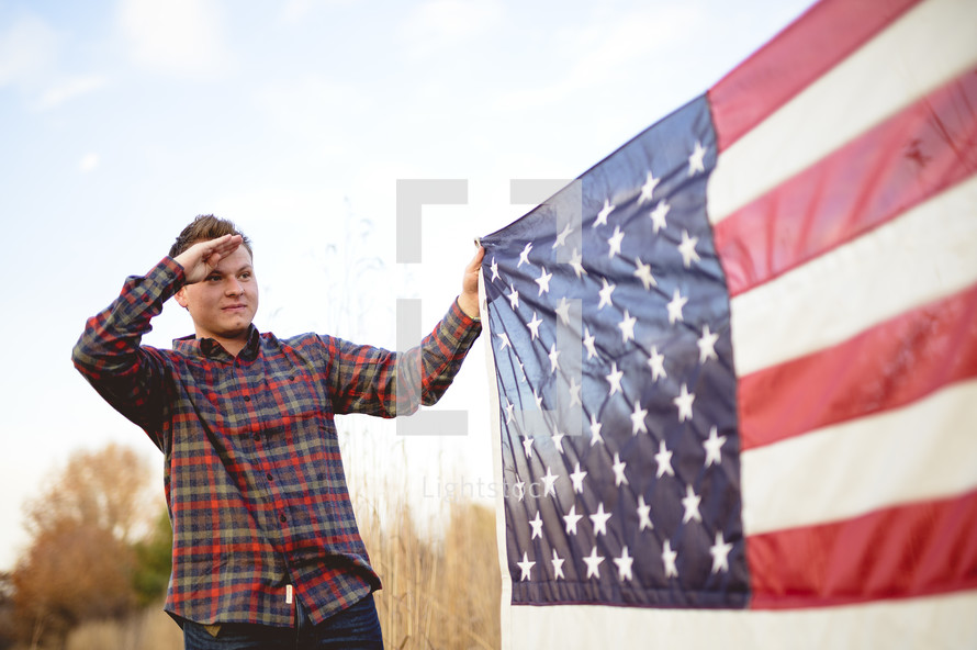 man saluting an American flag 